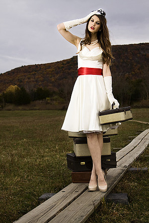 Fashion photography of woman in classic dress with antique luggage