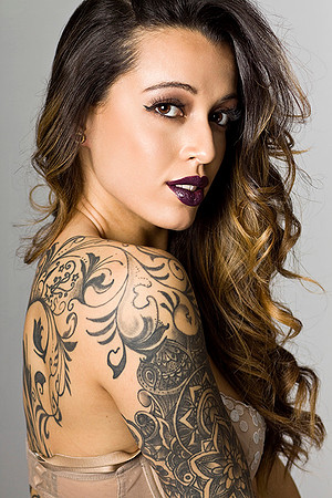 Profile beauty shot of woman with tattoos