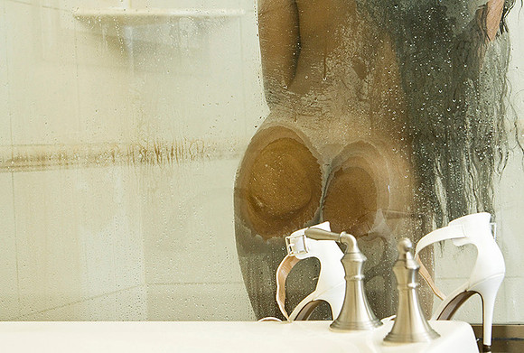 Woman's butt against shower wall